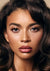 Close-up portrait of a model with natural freckles, dewy skin glow, soft eyeshadow, and glossy mauve lips