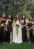 Bride and bridesmaids displaying elegant bridal makeup and styling by Karysha Beauty in an outdoor wedding group photo with calla lily bouquets