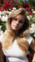 Blonde model with a voluminous blowout hairstyle and soft natural glam makeup by a Miami makeup artist and hair stylist