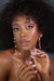 Woman holding makeup products with a dark background