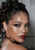 Close-up of a woman with braided hair and red lipstick 