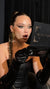 surprised glam client holding a mirror palette to see her edgy high-fashion makeup look