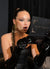 amazed woman in black leather gloves reacting with awe to her graphic winged eyeliner and sparkling eye makeup created by Karysha Beauty