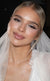 Close-up portrait of a gorgeous bride with a veil, wearing glowing soft-glam bridal makeup with glossy lips by Karysha Beauty.