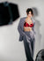 Karysha wearing a red bra and gray suit against a plain background