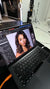 Laptop screen displaying a photo editing session of a model with bronzed glam makeup and voluminous curls